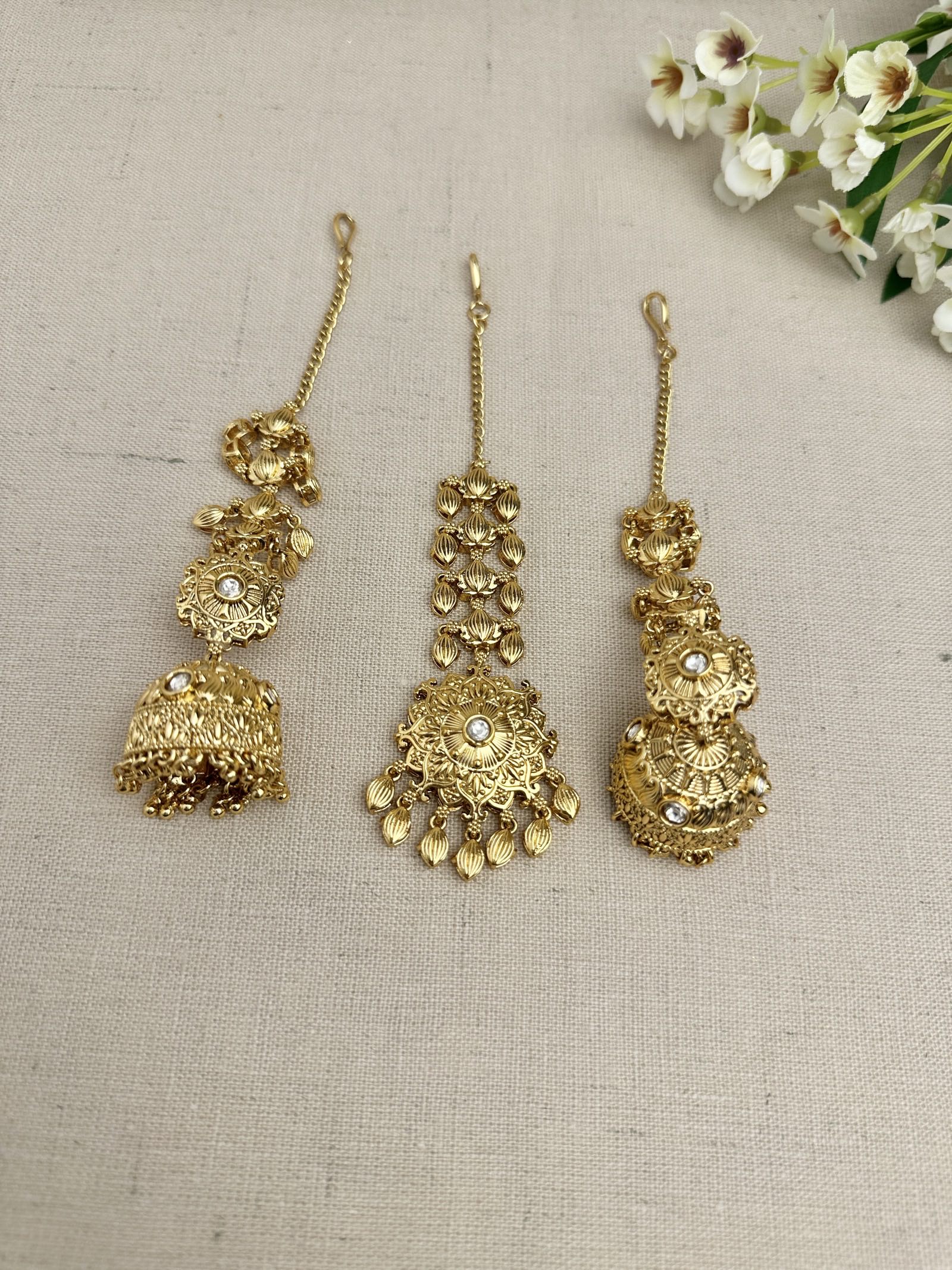 Side view of the Simran Gold-Plated Punjabi Jhumki & Tikka Set highlighting the single jhumki design and sahara chain.