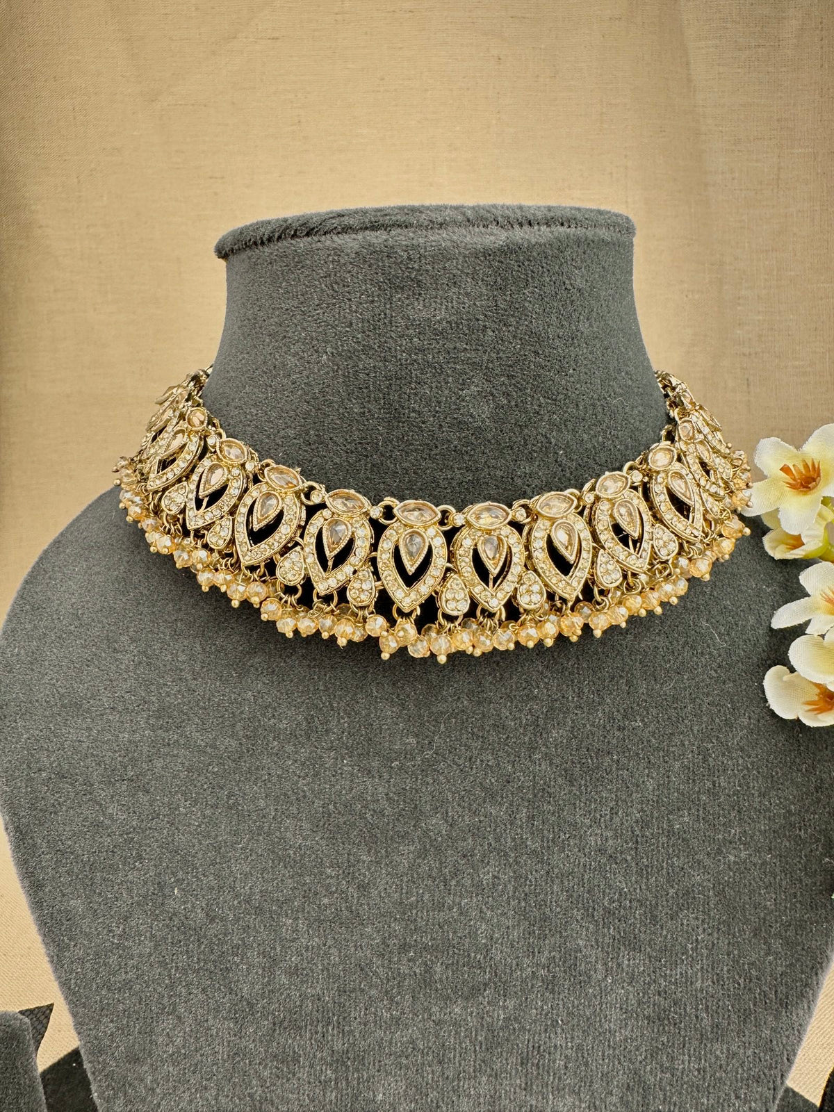Close-up of Ziya champagne choker necklace with sparkling stone and bead detailing